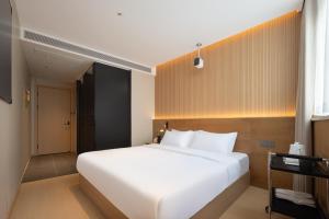 Shanghai Captain 5 Youth Hotel - Xinzhuang Metro Station 객실 침대
