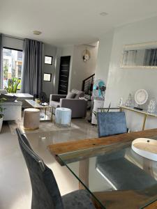a living room with a glass table and chairs at Casa Almera in Totolan