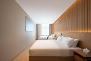 Shanghai Captain 5 Youth Hotel - Xinzhuang Metro Station 객실 침대