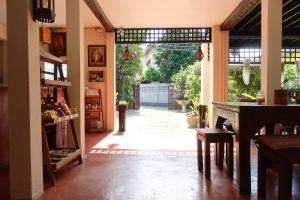 an open door to a patio with a table in a room at Banjai Garden Guesthouse in Chiang Mai