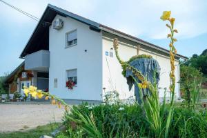 a white house with a plant in front of it at Apartment Nina in Slunj