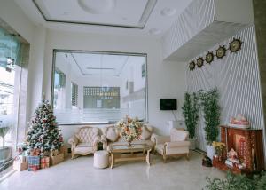 a living room with a christmas tree in the corner at Thuan Phat House Soc Trang in Soc Trang