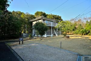 a house with a parking lot in front of it at Green Room - グリーンルーム志摩 in Shima