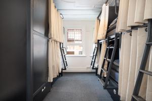 a hallway of a room filled with bunk beds at Tequila Sunrise Potts Point in Sydney +101 photos