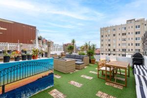 an outdoor patio with a table and chairs on a roof at Tequila Sunrise Potts Point in Sydney