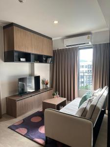 a living room with a couch and a tv at La Casita Hua-Hin By 95 Group in Hua Hin +40 photos