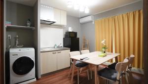 a small kitchen and dining room with a table at HANASTAY花渓居 椿Tsubaki in Osaka