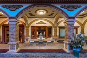 a large lobby with a table and chairs at 万象莉莉酒店 Lilyhotel in Vientiane