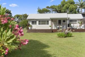 BerraraにあるBerrara Beach House - Belle Escapes Jervis Bayの花の庭のある白い家