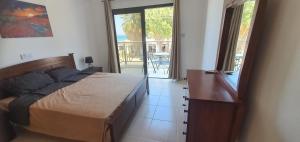 a bedroom with a bed and a door to a patio at Lavin - 3Bedroom Maisonette in Argaka