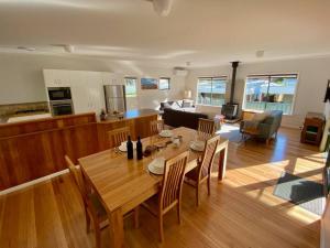 a dining room and living room with a table and chairs at Town Hideaway - Sleeps 6 in Margaret River Town