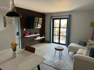 a living room with a couch and a table at Suites Miramar14 in Ensenada
