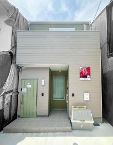 a building with a bench in front of it at HANASTAY花渓居 椿Tsubaki in Osaka