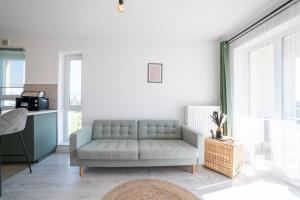 a living room with a couch and a table at Modern Coresi Studio - Free Private Parking by MM Host in Braşov