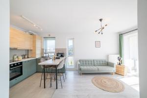 a kitchen and living room with a couch and a table at Modern Coresi Studio - Free Private Parking by MM Host in Braşov