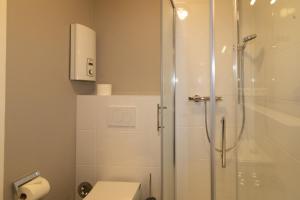 a bathroom with a shower and a toilet at Sylt for Friends in Hörnum +8 photos