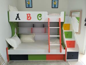 a bunk bed with a ladder in a room at Sea view Luxury Flat 2BHK ,Ajman in Ajman 