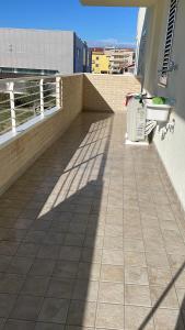 a shadow on a tile floor on a balcony at Falce di luna in Tortoreto Lido