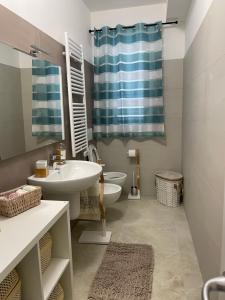 a bathroom with a sink and a toilet and a mirror at Falce di luna in Tortoreto Lido