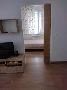 a room with a bedroom with a bed and a mirror at ЕкоПойнт in Chernomorets +2 photos