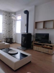 a living room with a couch and a fireplace at ЕкоПойнт in Chernomorets
