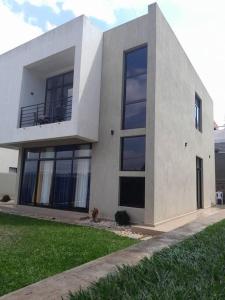 a white building with a balcony on top of it at Dafrican BnB villa in Kigali