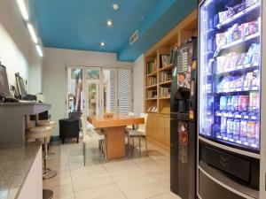 a restaurant with a refrigerator and a table in it at Hotel Sagrada Familia in Barcelona