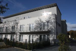 a white building with a balcony on the side of it at Victoria Living in Jockgrim