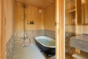 a bathroom with a bath tub in a room at Obama Machiya Stay in Obama +53 photos