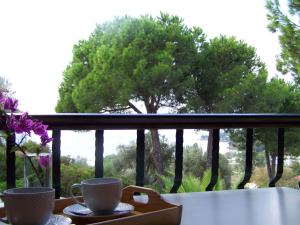 two coffee cups on a tray on a balcony at Villa Anna Maria in Agia Paraskevi