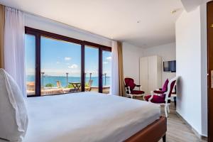 A bed or beds in a room at Mangana Konak Hotel