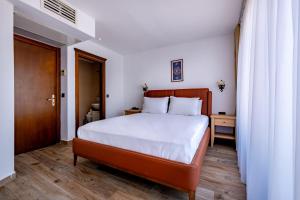 A bed or beds in a room at Mangana Konak Hotel