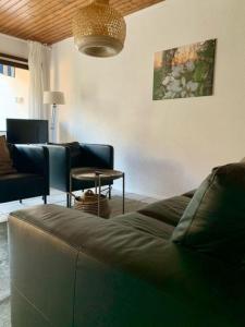 a living room with a couch and a table at Haus Delbar in Bodman-Ludwigshafen