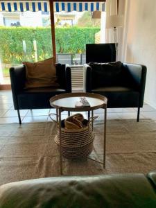 a living room with two couches and a table at Haus Delbar in Bodman-Ludwigshafen +6 photos