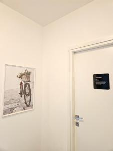 a picture of a bike on a wall next to a door at Vicky's House Venezia in Chirignago