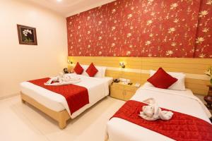 Postel nebo postele na pokoji v ubytování Hotel DSF Grand Plaza