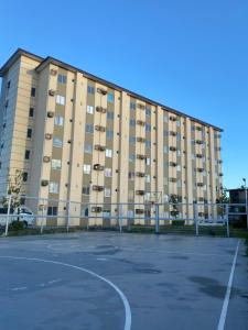 an empty parking lot in front of a large building at Kral Suite in Las Piñas in Manila