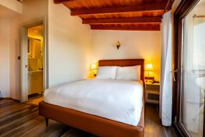 A bed or beds in a room at Mangana Konak Hotel