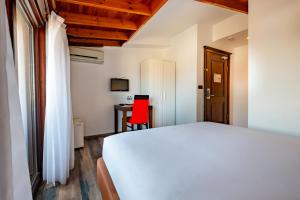 A bed or beds in a room at Mangana Konak Hotel