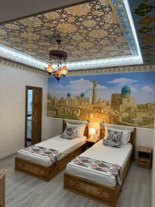 two beds in a room with a painting on the wall at SILVER Terrace in Bukhara +67 photos