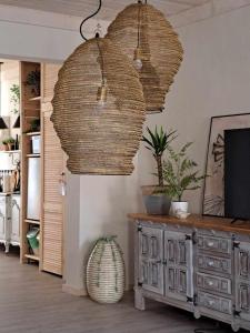 a living room with two hanging baskets and a television at Apartament w Fabryce Czekolady in Bytom +63 photos
