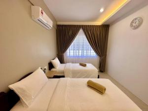 a hotel room with two beds and a window at Jk Home Stampin Semi-Detached 12pax 4BedR 3BathR 4Carparks in Kuching +74 photos