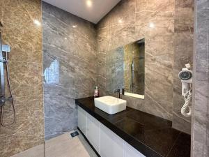 a bathroom with a sink and a shower at Jk Home Stampin Semi-Detached 12pax 4BedR 3BathR 4Carparks in Kuching +74 photos