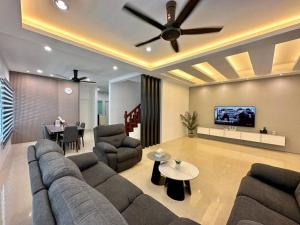 a living room with a couch and a ceiling fan at Jk Home Stampin Semi-Detached 12pax 4BedR 3BathR 4Carparks in Kuching