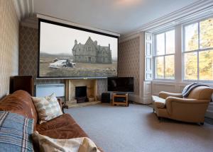 a living room with a large picture of a house at Tarbert Country Manor in Tarbert