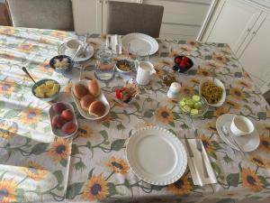 a table with plates and bowls of food on it at La Casa di Stella in Porto SantʼElpidio