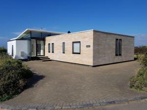 a house with a large driveway in front of it at Luminaire hosted accommodation in Guernsey