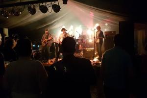 a group of musicians on a stage at a concert at Luminaire hosted accommodation in Guernsey