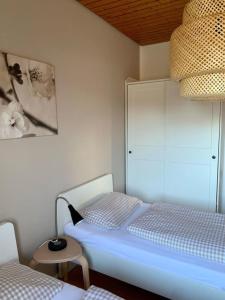 a bedroom with a bed with a lamp and a chair at Haus Elstar in Bodman-Ludwigshafen