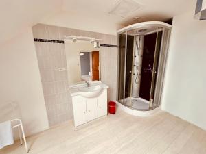 a bathroom with a sink and a toilet and a shower at La Tanière in Tardinghen +18 photos